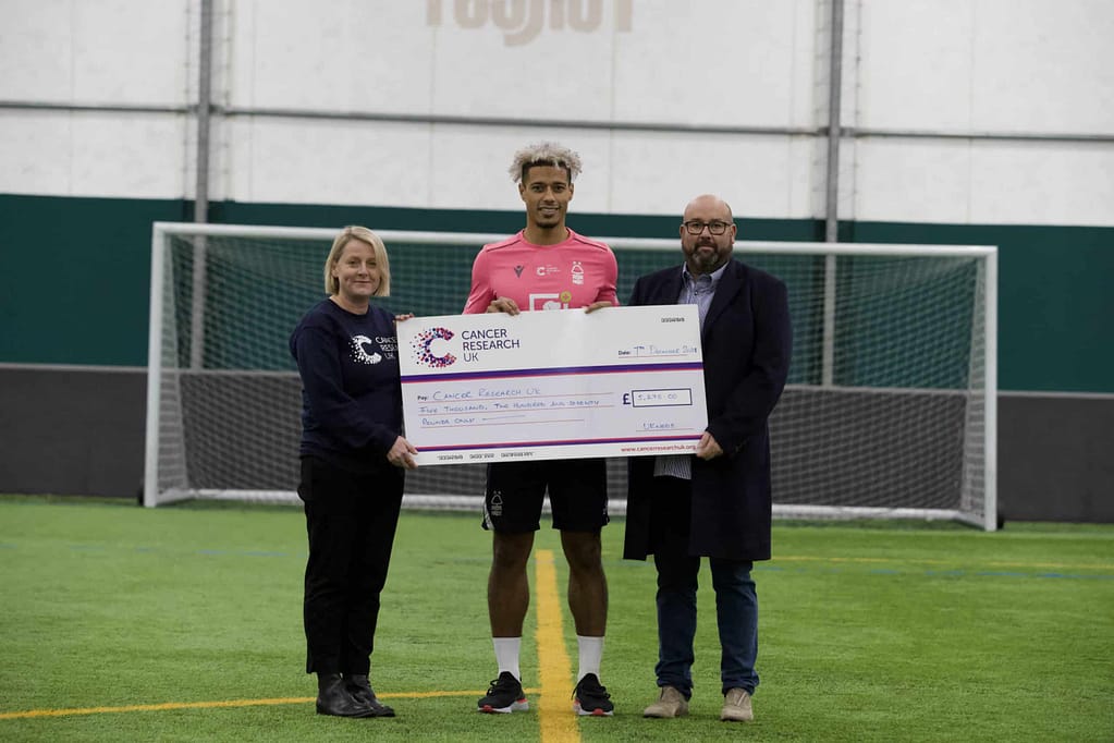 UK Meds present cheque to Nottingham Forest footballer Lyle Taylor